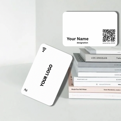 White business cards with customizable text and a QR code on a gray surface.